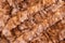 Background in the form of stitched pieces of natural fur light brown color