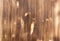 Background in the form of a wooden surface, lightly treated with a fire of light brown color with vertical textural stripes on the