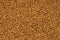 Background of freeze-dried granulated instant coffee macro close-up.