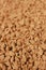 Background of freeze-dried granulated instant coffee macro close-up.