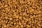 Background of freeze-dried granulated instant coffee macro close-up.