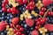 Background of fresh berries and fruits. Ripe bilberries, blueberries, currants, and raspberries. Mixed berries and fruits. Top vie