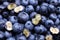 Background of fresh blueberries with cut halves macro close up, concept of organic wholesome food