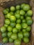 Background of fresh green limes closeup, fruits on sale, mobile photo