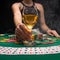 Background of a gaming casino, poker table, cards, chips and a girl with a glass of wine and smoke. Background for a gaming