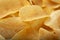 Background golden potato chips texture. Crispy unhealthy snack isolated