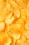 Background of golden wavy corrugated chips large slices with sea