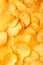 Background of golden wavy corrugated chips large slices with sea