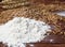 Background of Golden wheat grains and white crumbling flour scattered on wooden table