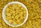 Background of goldish corn flakes with dish