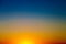 Background with gradient sunset sky in tones of yellow, orange and blue