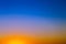 Background with gradient sunset sky in tones of yellow, orange and blue