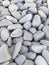 Background of gray sea stones of different shapes and tones. Small Naturally Polished Rocks, Pebbles background and pattern