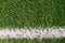 Background of green artificial grass. Marked white lines on the sports field