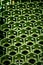 The background of green cells of hexagonal shape is a plastic container. Honeycomb s in perspective