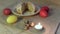 Background for a greeting card: closeup burning light candle, colorful Easter eggs in the background and Eas