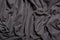 Background of grey folds fabric texture. Grey textile. Top view