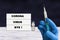 Background with hand, vaccine and text Coronavirus bye on white board