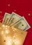 Background for holiday card with money US dollars. Background of one hundred dollar bills. Banknotes, paper currency on red