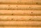 Background of horizontal hewed painted wooden logs