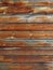 Background of horizontal weathered wooden slats. Wooden panel or fence made of planks, and the old boards can serve as a backdrop