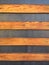 Background of horizontal wooden sheets, separated and nailed on black wall. Abstract pattern and texture. Old wood background