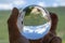 Background with houses and mountains seen through a crystal ball