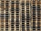 background of hundreds of wooden pallets in the warehouse of the