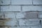 Background image of an abandoned brick wall with painted over paint