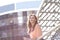 Background image of a brooding business woman standing on the balcony of an office building