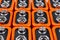 Background image of a large number of orange batteries, standing in several rows