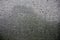 Background image of rain drops on a glass window, which is protected by a mosquito net. Macro photo with shallow depth of fiel