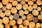 Background image of stacked round logs.