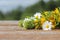 Background for an inscription. Wild flowers on a wooden table in