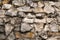 The background of irregular cobblestones is light beige and gray. Design backgrounds textures