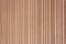 Background of light brown boards with grooves made of vertical tongue and groove boards