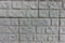 Background - light gray unpainted brick veneer wall