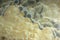 Background from a light natural stone Onyx with bubbles and gray stains on the surface, onix naranja veteado