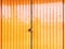 Background of Locked Corrugated Yellow Shutter Door