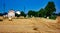 Background. lowland landscape with farm. field with bales of harvested hay.