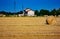 Background. lowland landscape with farm. field with bales of harvested hay.