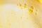 Background lush airy foam detergent bath gel bathing bright yellow. Fashion beauty concept top view copy space