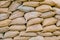 Background of lying dirty sandbags. Bags to strengthen the defensive structure during the battle. Sandbag flood protection wall