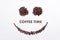 Background made of coffee beans in a smiley face shape with message `Coffee time`