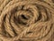 The background is made of coiled coarse twisted rope