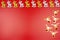 Background made of gold and silver reindeer and reindeer faces on the right, isolated on a red background.