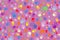 Background of many colored fingerprints on a pink background
