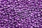 A background of many shiny purple metallic balls. Metallic balls of amethyst color