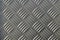 Background of metal with repetitive patterns diamonds