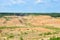 Background of mountain showing yellow soil and rock. View on the canyon with cracks in sand. Mining and Water Pollution. Exhausted